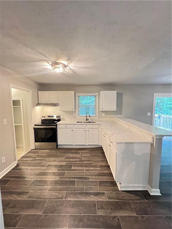 2838 The Meadows Way College Park, GA 30349 - Photo 4 of 10 a view of a kitchen with cabinets and wooden floor