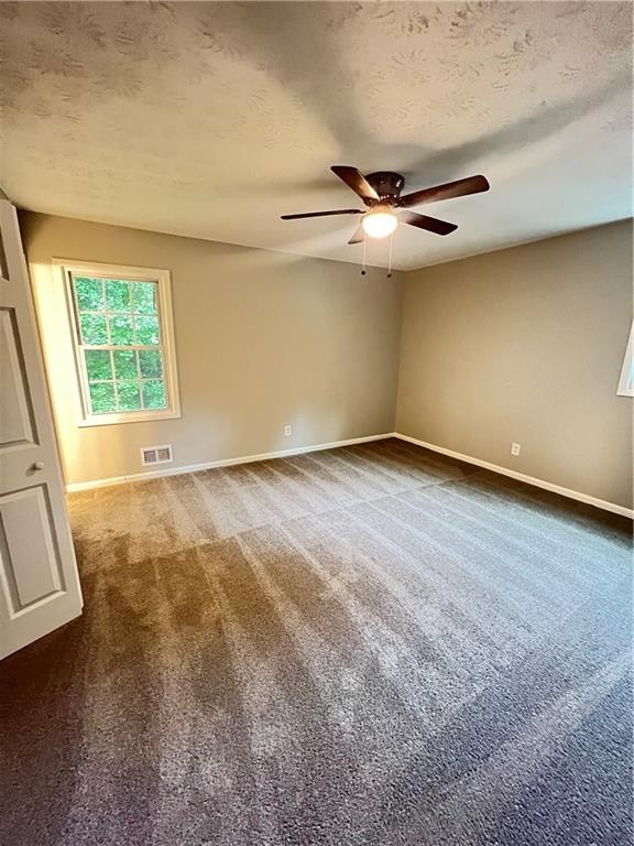 2838 The Meadows Way College Park, GA 30349 - Photo 6 of 10 an empty room with a ceiling fan and window