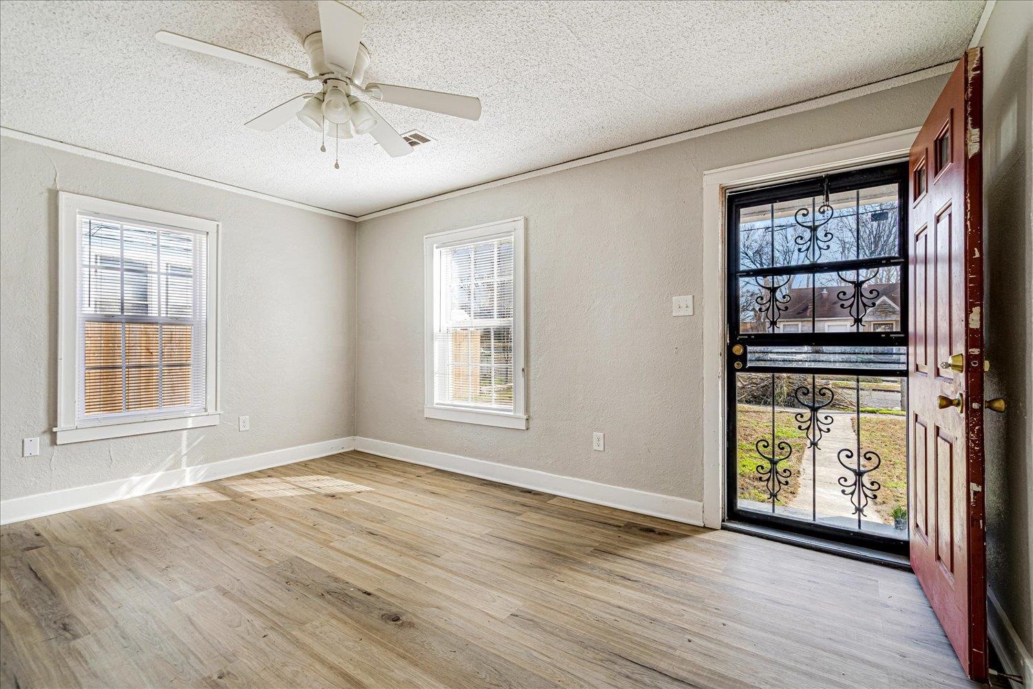3084 Pershing Avenue Memphis, TN 38112 - Photo 12 of 30 Foyer featuring ceiling fan, a textured wall, light wood-style flooring, and a textured ceiling