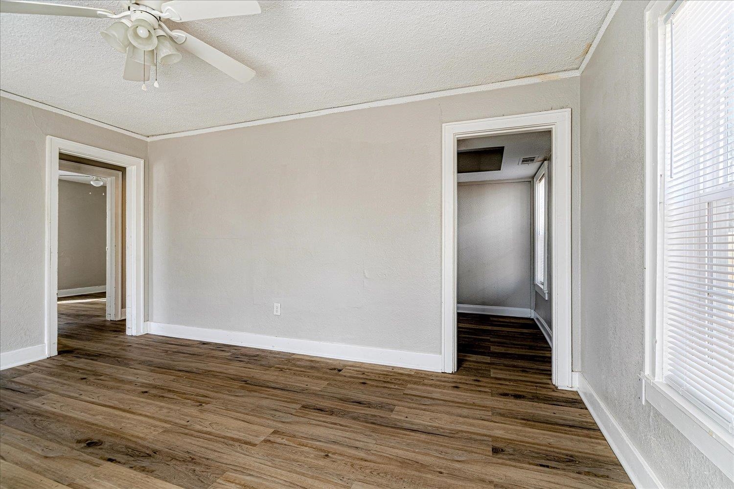 3084 Pershing Avenue Memphis, TN 38112 - Photo 13 of 30 a view of an empty room with wooden floor and a window
