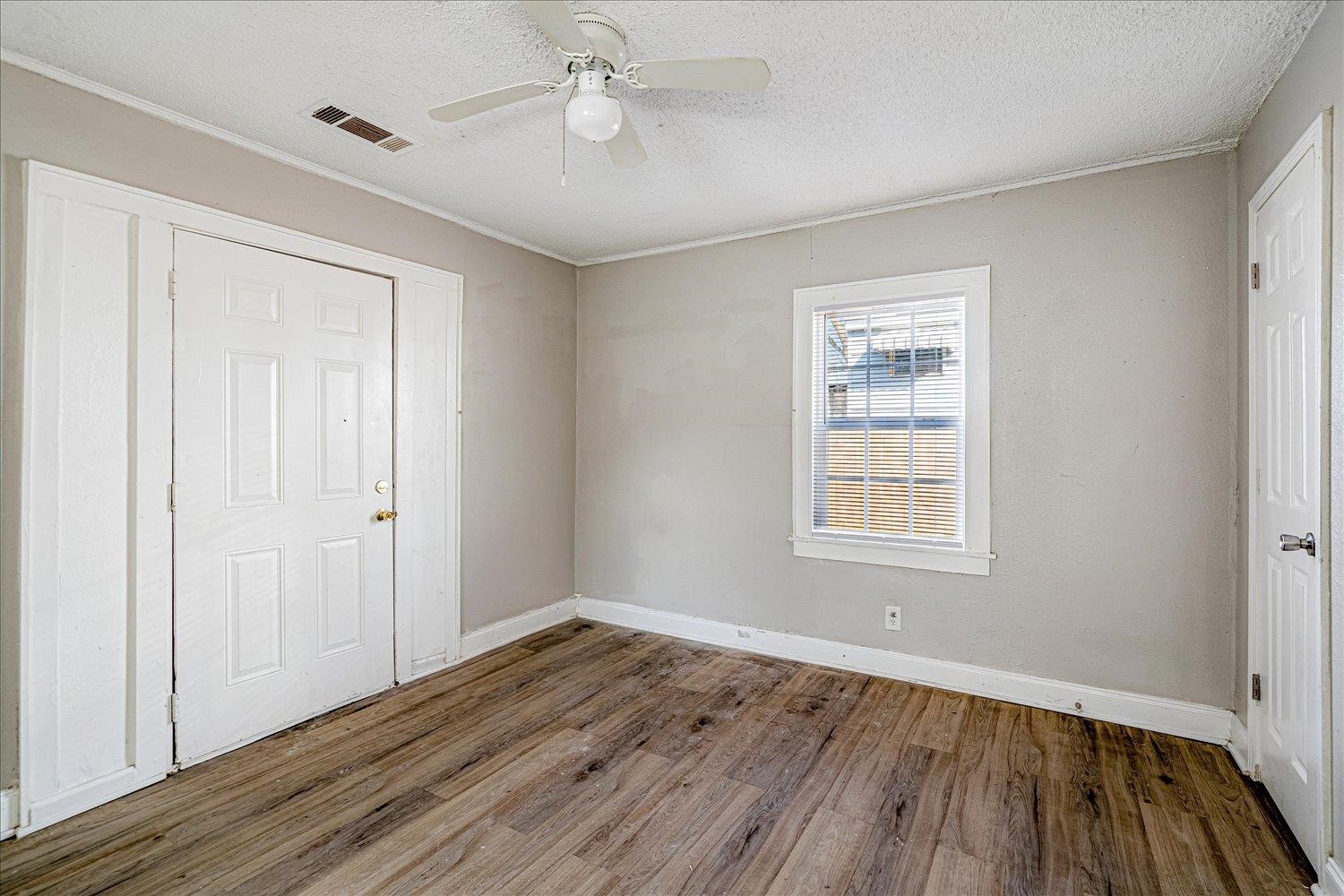 3084 Pershing Avenue Memphis, TN 38112 - Photo 18 of 30 Unfurnished bedroom with a textured ceiling, dark wood-style floors, and ceiling fan