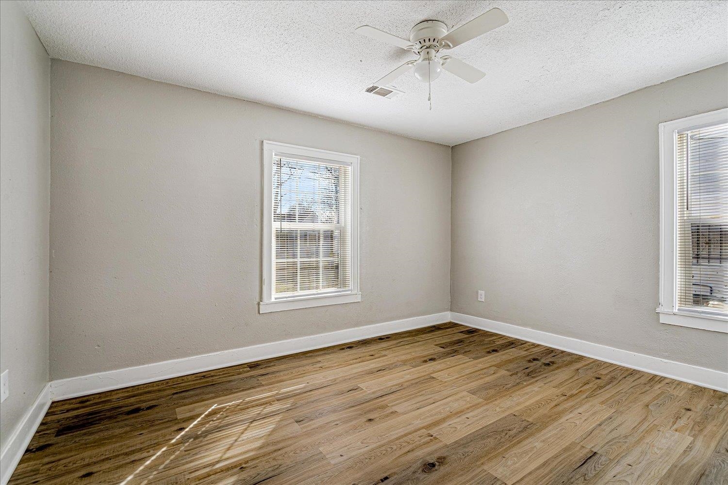 3084 Pershing Avenue Memphis, TN 38112 - Photo 22 of 30 Spare room with light wood-style floors, ceiling fan, and a textured ceiling
