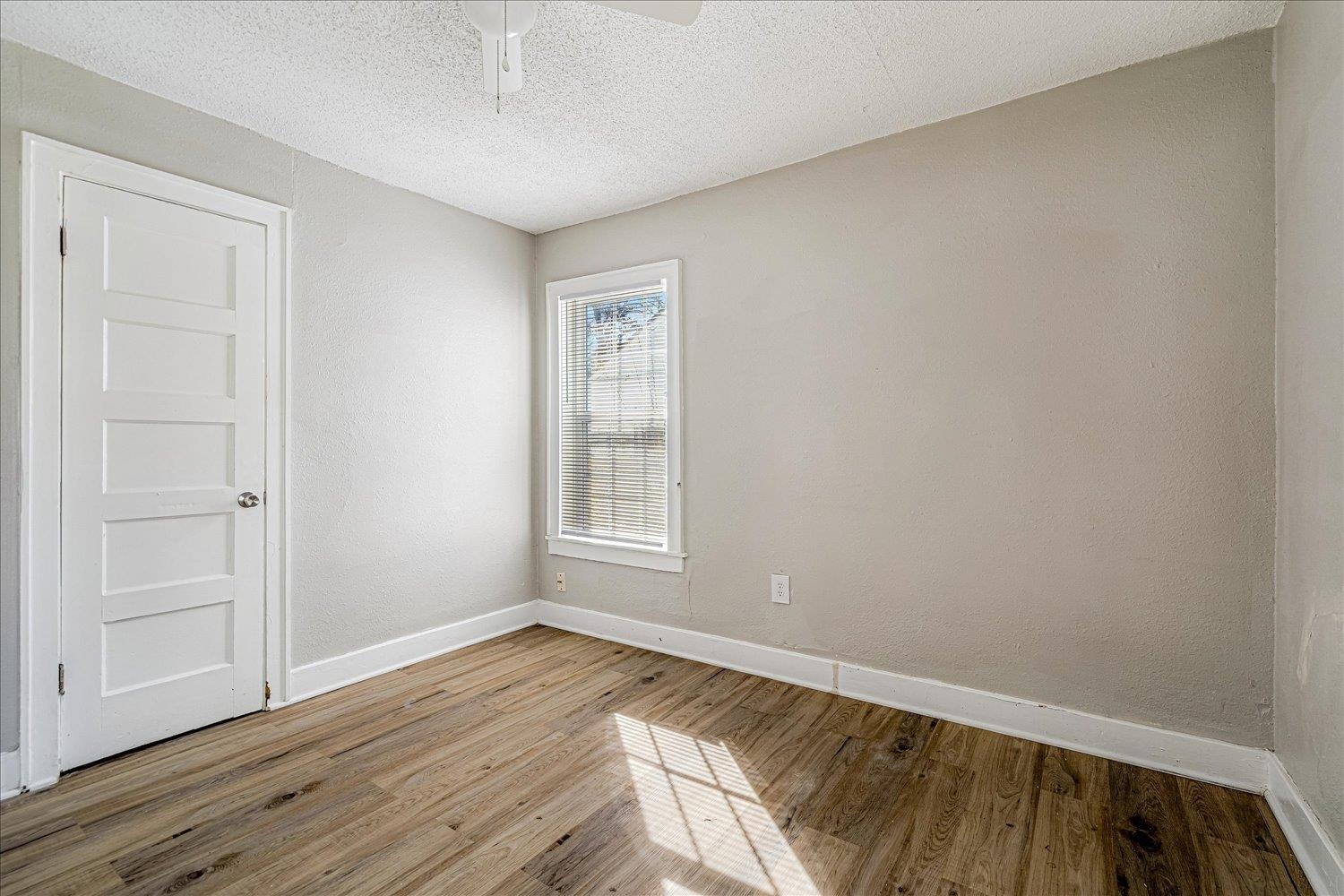 3084 Pershing Avenue Memphis, TN 38112 - Photo 25 of 30 a view of an empty room with wooden floor and a window