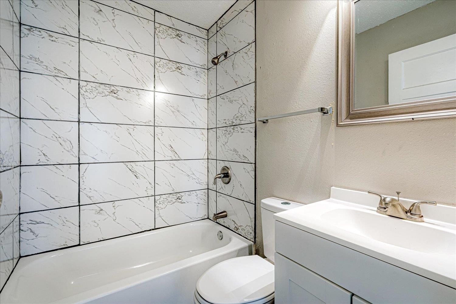 3084 Pershing Avenue Memphis, TN 38112 - Photo 26 of 30 Full bath with a textured wall, shower / washtub combination, and vanity