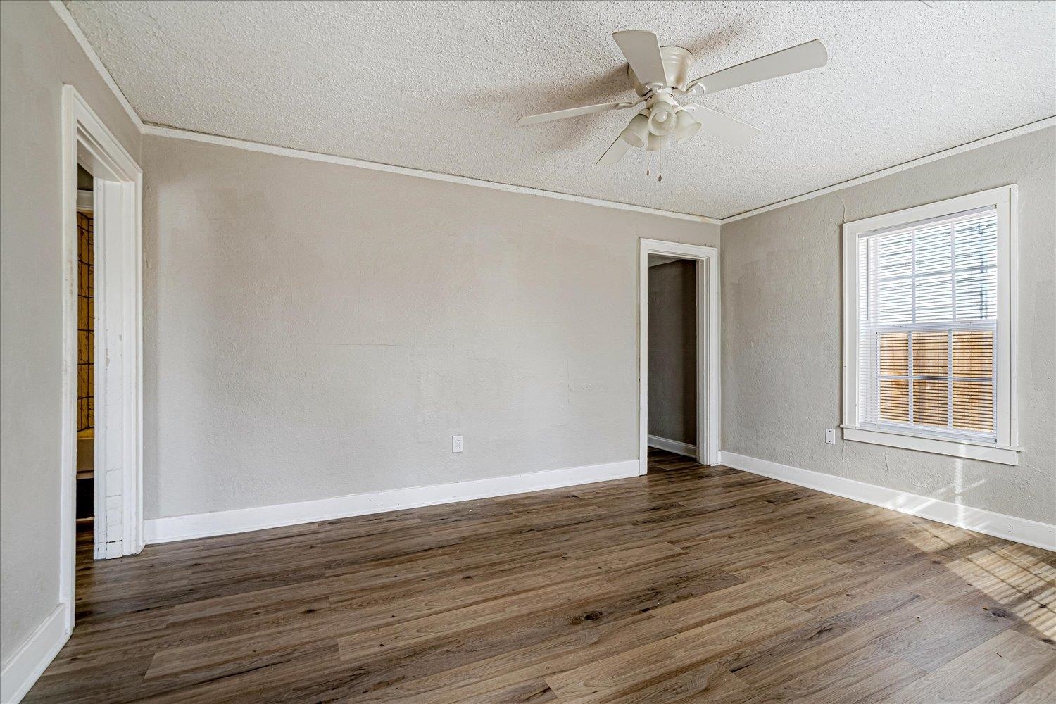 3084 Pershing Avenue Memphis, TN 38112 - Photo 9 of 30 a view of an empty room with wooden floor and a window