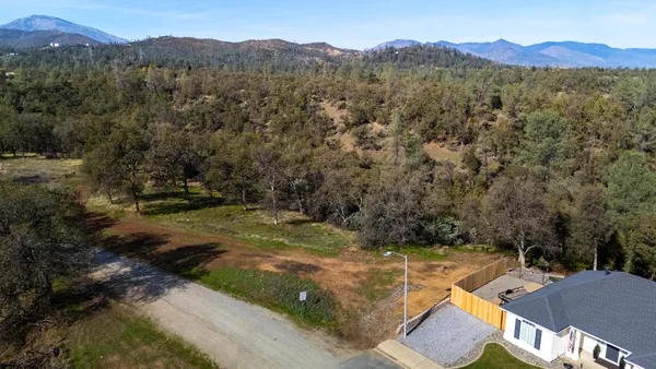 an aerial view of a house with a yard