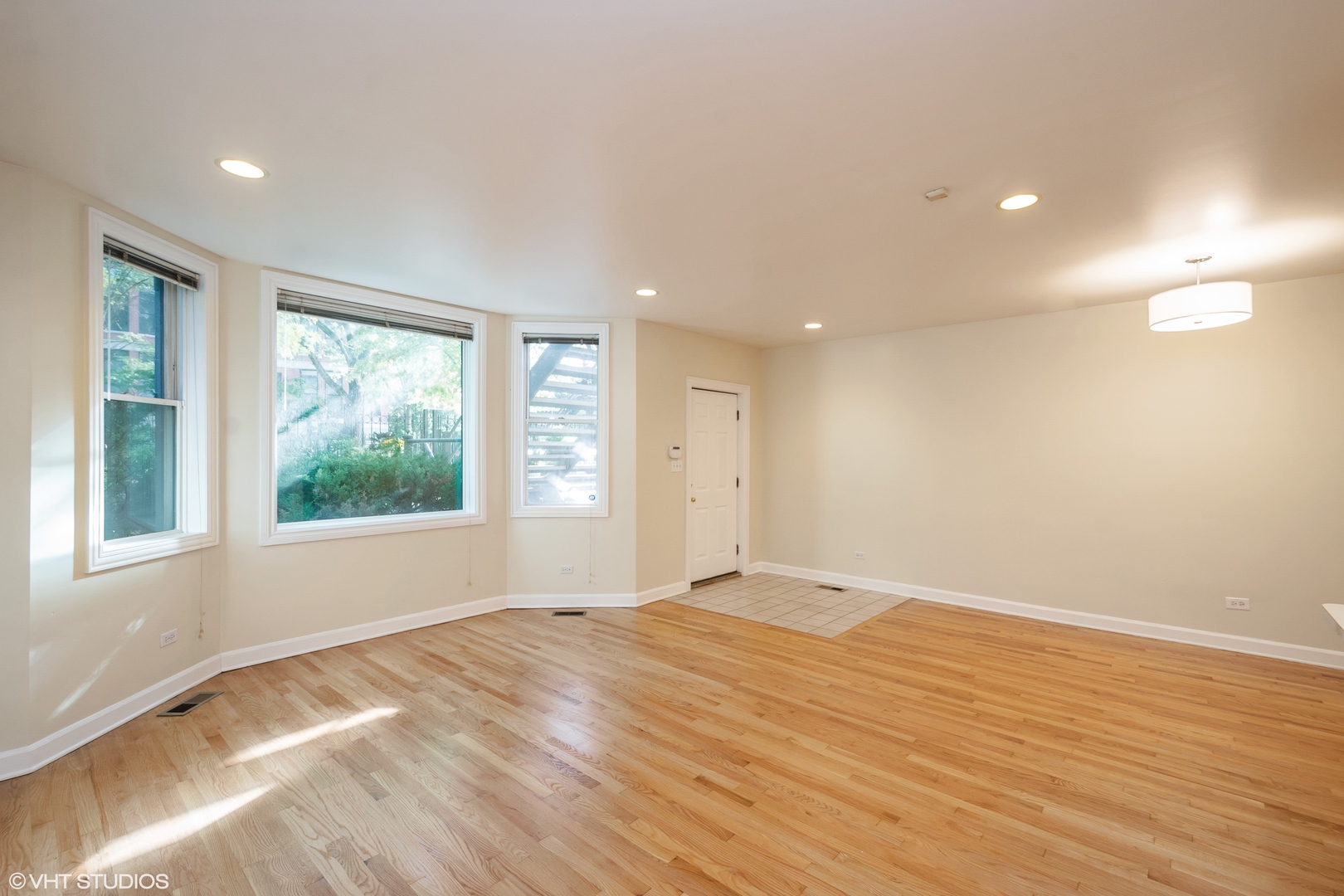 1550 West Jackson Boulevard, Unit 1 Chicago, IL 60607 - Photo 4 of 10 a view of empty room with wooden floor and fan