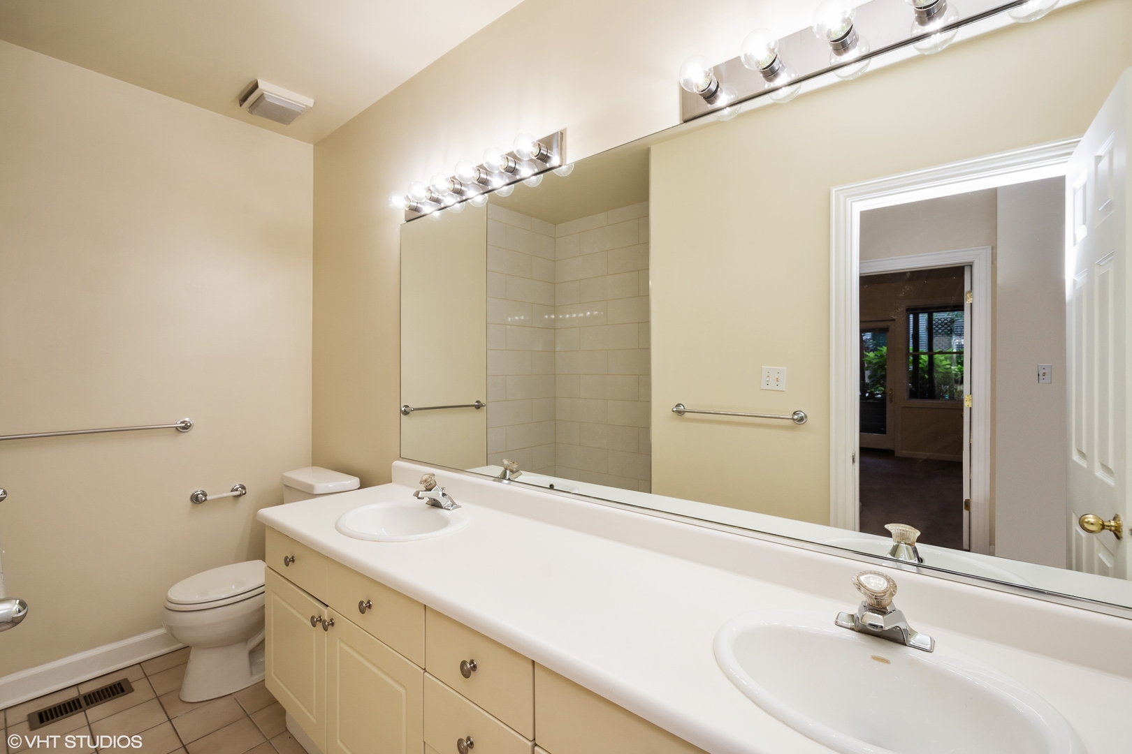 1550 West Jackson Boulevard, Unit 1 Chicago, IL 60607 - Photo 9 of 10 a bathroom with a sink a toilet and a mirror