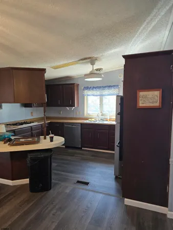 a kitchen with kitchen island a sink appliances and cabinets
