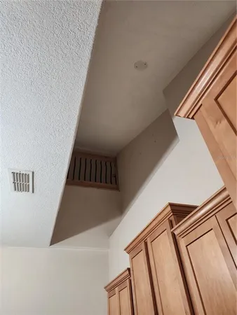 a view of an empty room and wooden floor