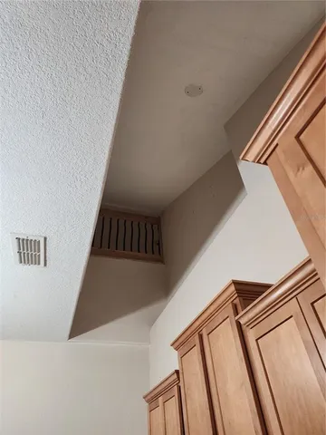 a view of an empty room and wooden floor