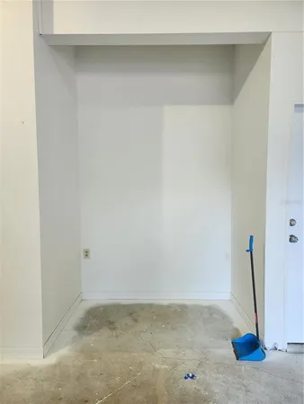 a view of hallway with closet and wooden floor