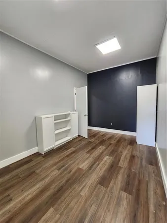 an empty room with a empty space and windows