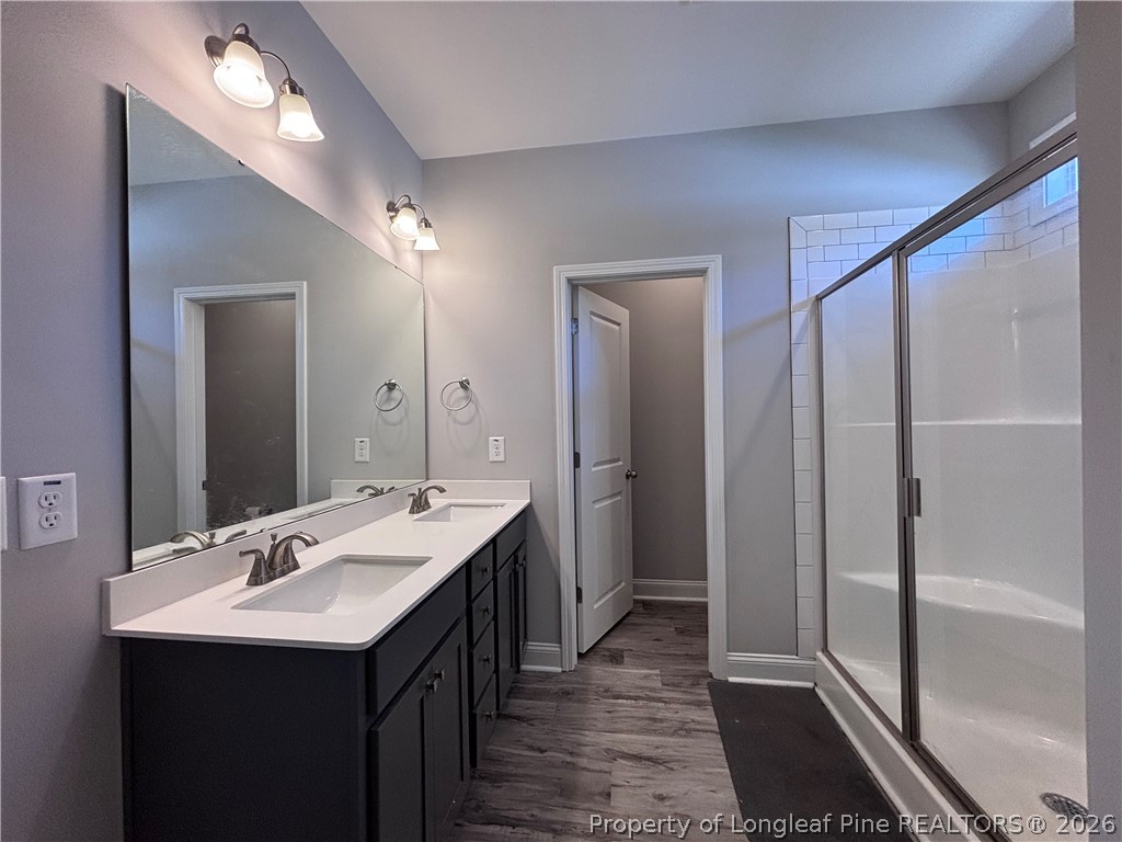 7720 Rufus Johnson Road Fayetteville, NC 28306 - Photo 47 of 50 a bathroom with a double vanity sink and a mirror