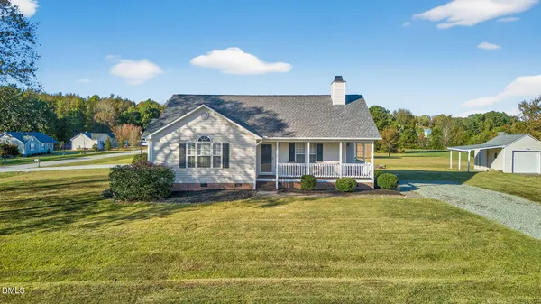a view of a house with swimming pool and a yard