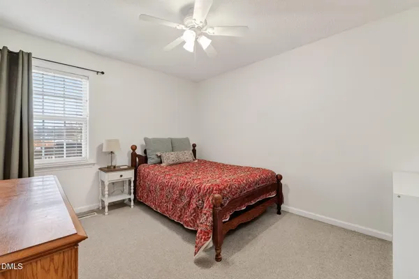 a spacious bedroom with a bed and a desk