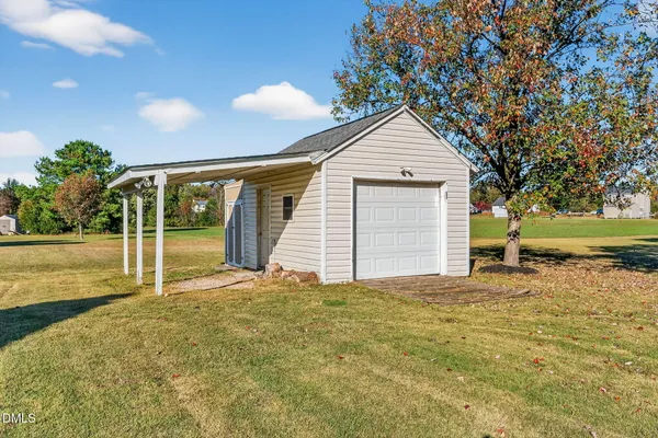 a view of a house with a yard and garage