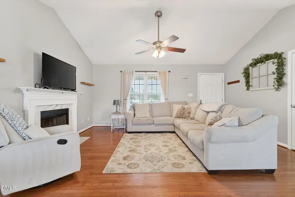 a living room with furniture fireplace and flat screen tv