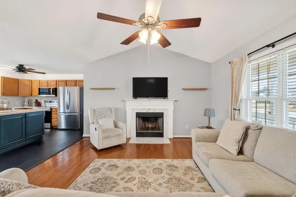 a living room with furniture fireplace and flat screen tv