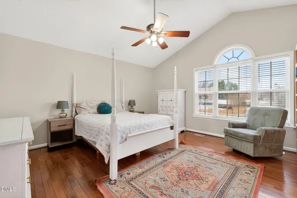 a bedroom with a bed a couch and a window