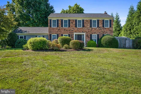 a view of a brick house with a yard