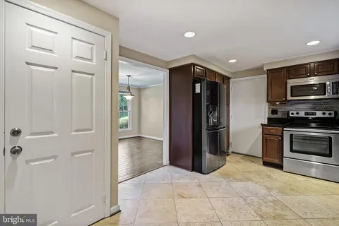 a kitchen with stainless steel appliances granite countertop a stove sink and cabinets