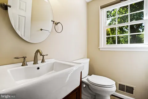a view of an empty room with a ceiling fan and a window