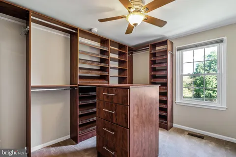 a view of a livingroom with a ceiling fan and entryway