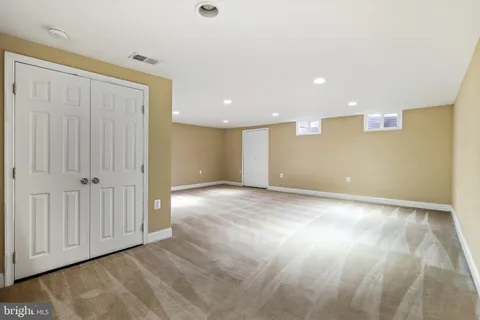 a bathroom with a granite countertop toilet sink and mirror