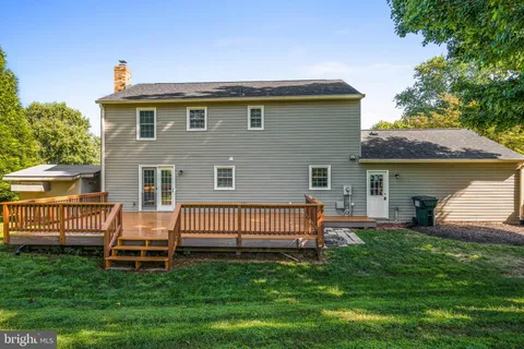 a view of a house with brick walls and a yard with plants
