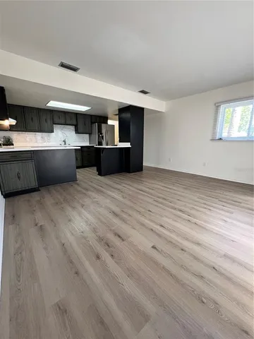 a view of kitchen with a sink and cabinets