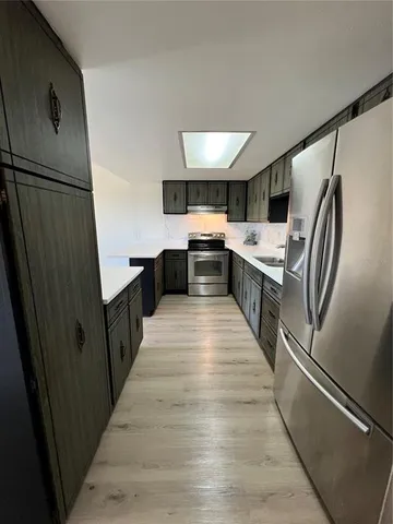 a kitchen with stainless steel appliances a refrigerator and a stove
