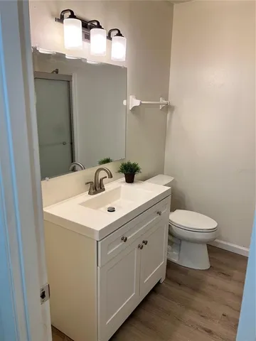 a bathroom with a toilet a sink and mirror