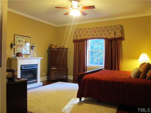 5 Chasewood Court Durham, NC 27703 - Photo 12 of 25 a bedroom with a bed and a fireplace