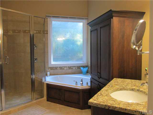 5 Chasewood Court Durham, NC 27703 - Photo 13 of 25 a bathroom with a tub sink and shower