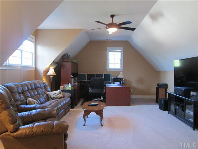5 Chasewood Court Durham, NC 27703 - Photo 17 of 25 a living room with furniture and a flat screen tv