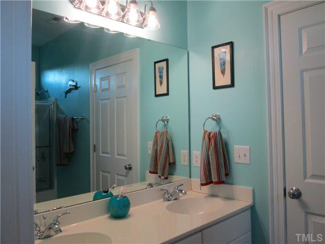 5 Chasewood Court Durham, NC 27703 - Photo 18 of 25 a bathroom with a double vanity sink and a mirror