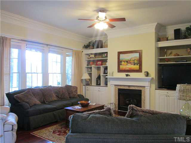 5 Chasewood Court Durham, NC 27703 - Photo 6 of 25 a living room with furniture a window and a fireplace