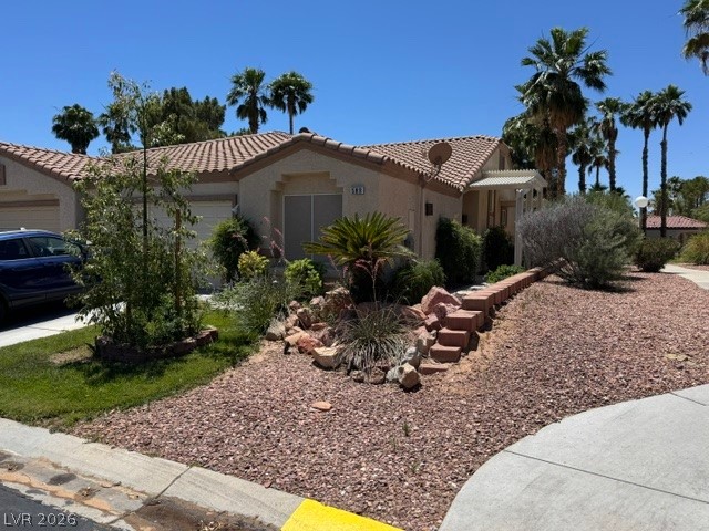 589 Beacon Ridge Way Mesquite, NV 89027 - Photo 1 of 18 Lush landscaping and mature palms define this inviting property with a charming front facade.