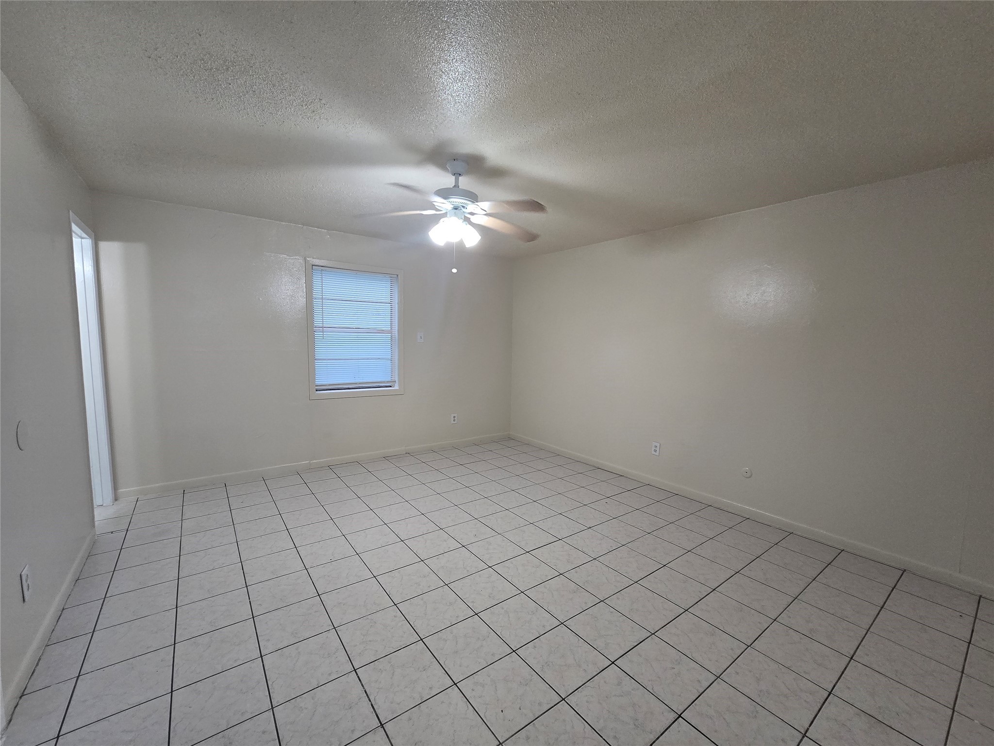 3714 Ave South, Unit 7 Galveston, TX 77550 - Photo 1 of 8 an empty room with windows and fan