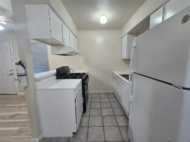 a utility room with cabinets washer and dryer