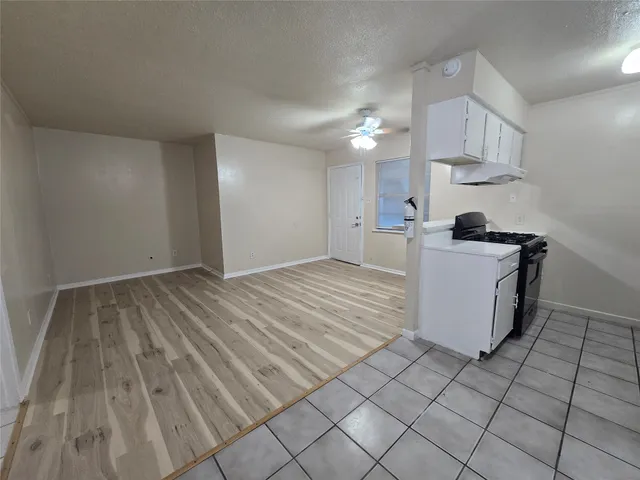 a kitchen with a sink a stove and cabinets