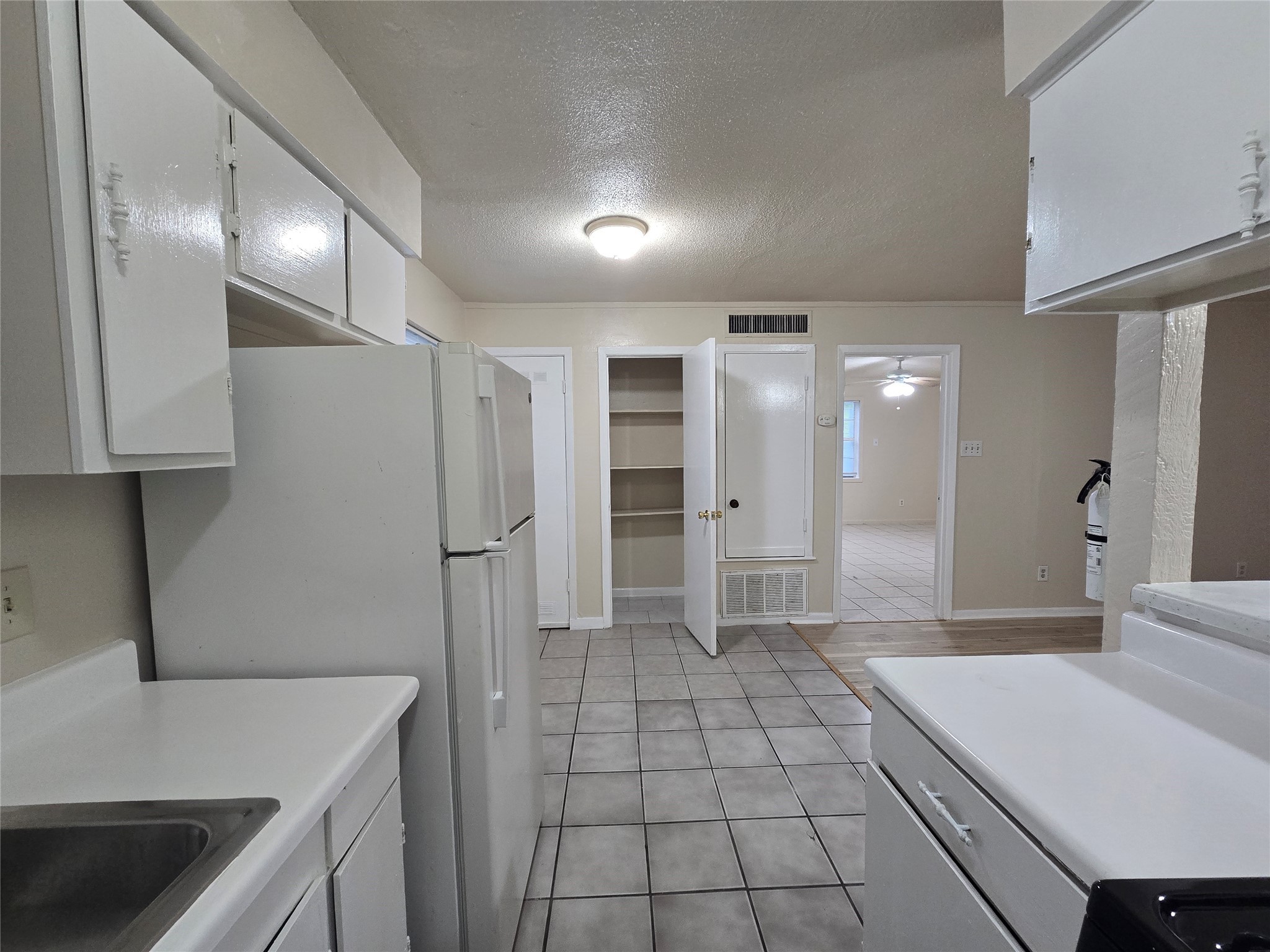 3714 Ave South, Unit 7 Galveston, TX 77550 - Photo 8 of 8 a kitchen with stainless steel appliances a refrigerator sink and cabinets