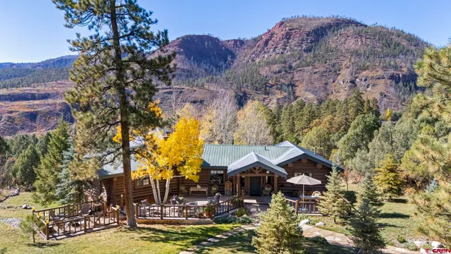 a view of a house with pool and sitting area
