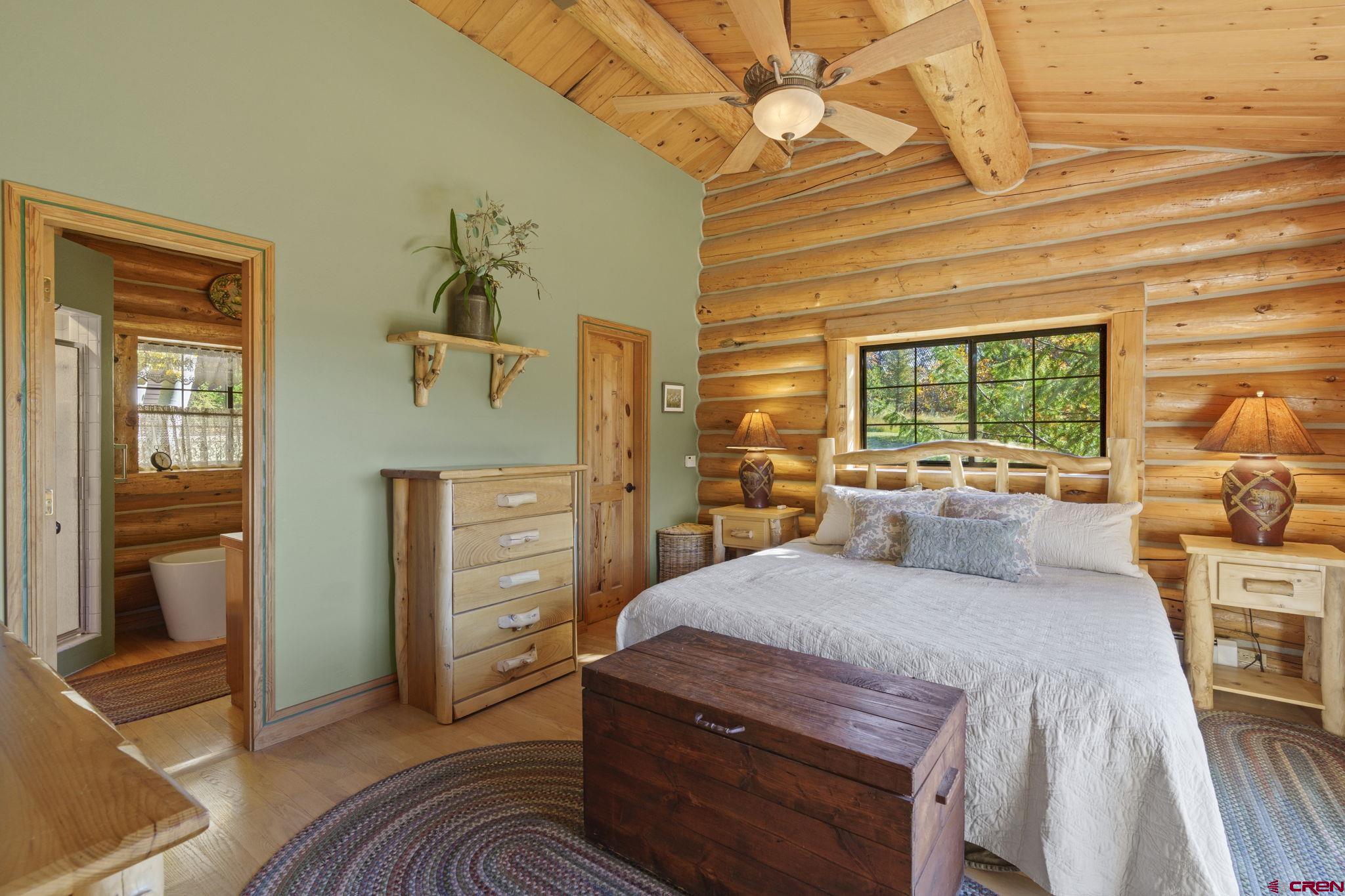 114 Rimrock Drive Durango, CO 81301 - Photo 14 of 42 a bedroom with a bed and wooden floor