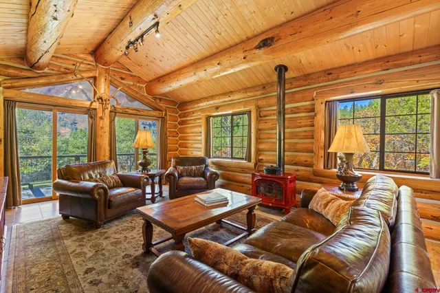 a living room with furniture a large window