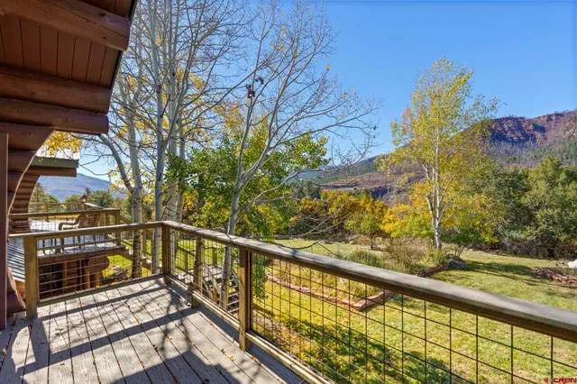 a view of balcony with wooden floor and fence