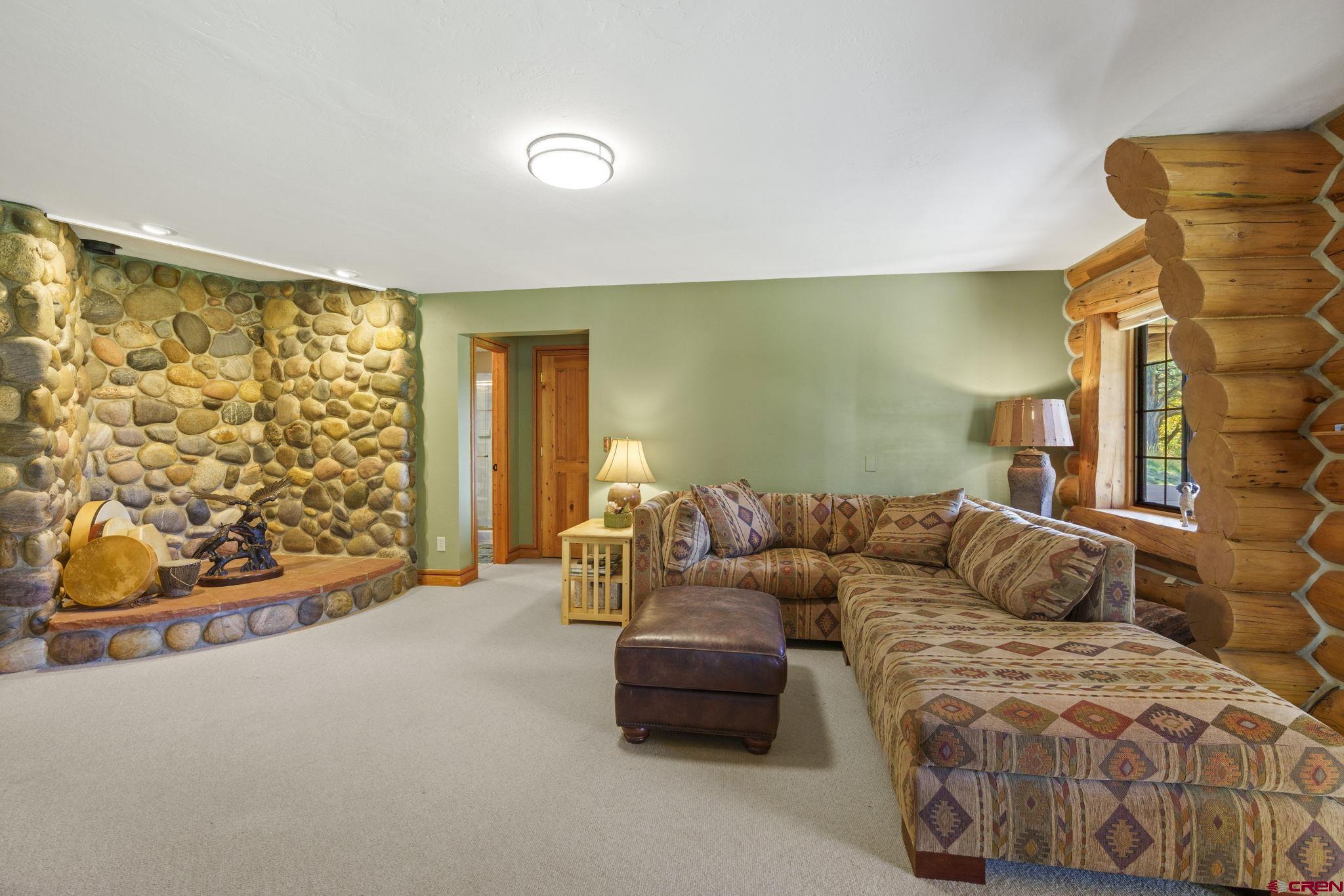 114 Rimrock Drive Durango, CO 81301 - Photo 20 of 42 a bedroom with a bed and a couch