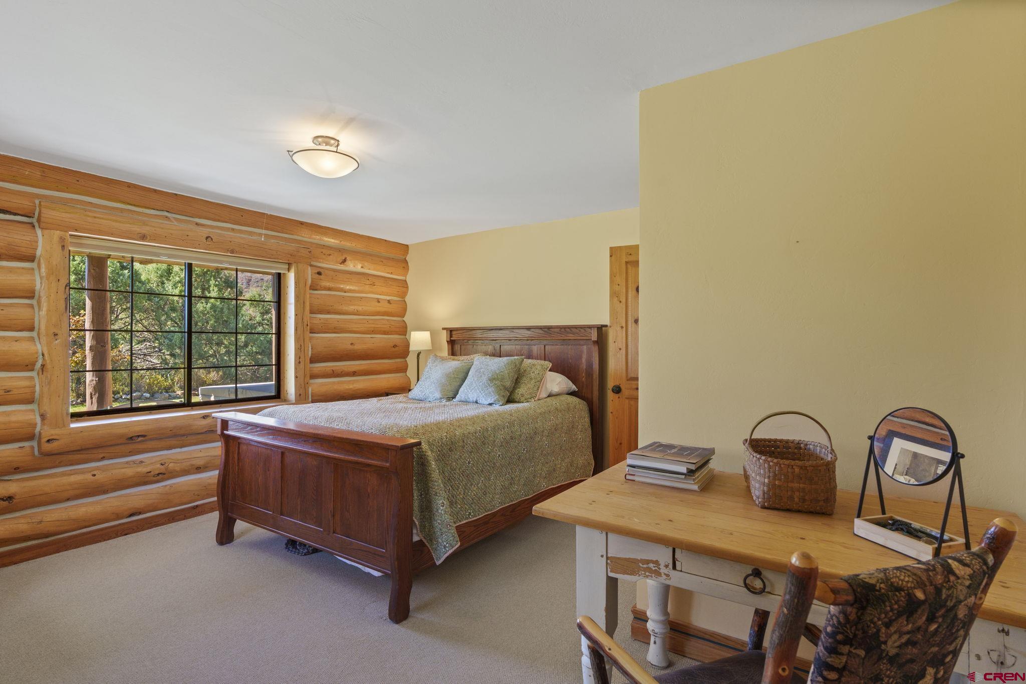 114 Rimrock Drive Durango, CO 81301 - Photo 22 of 42 a bedroom with a bed and window