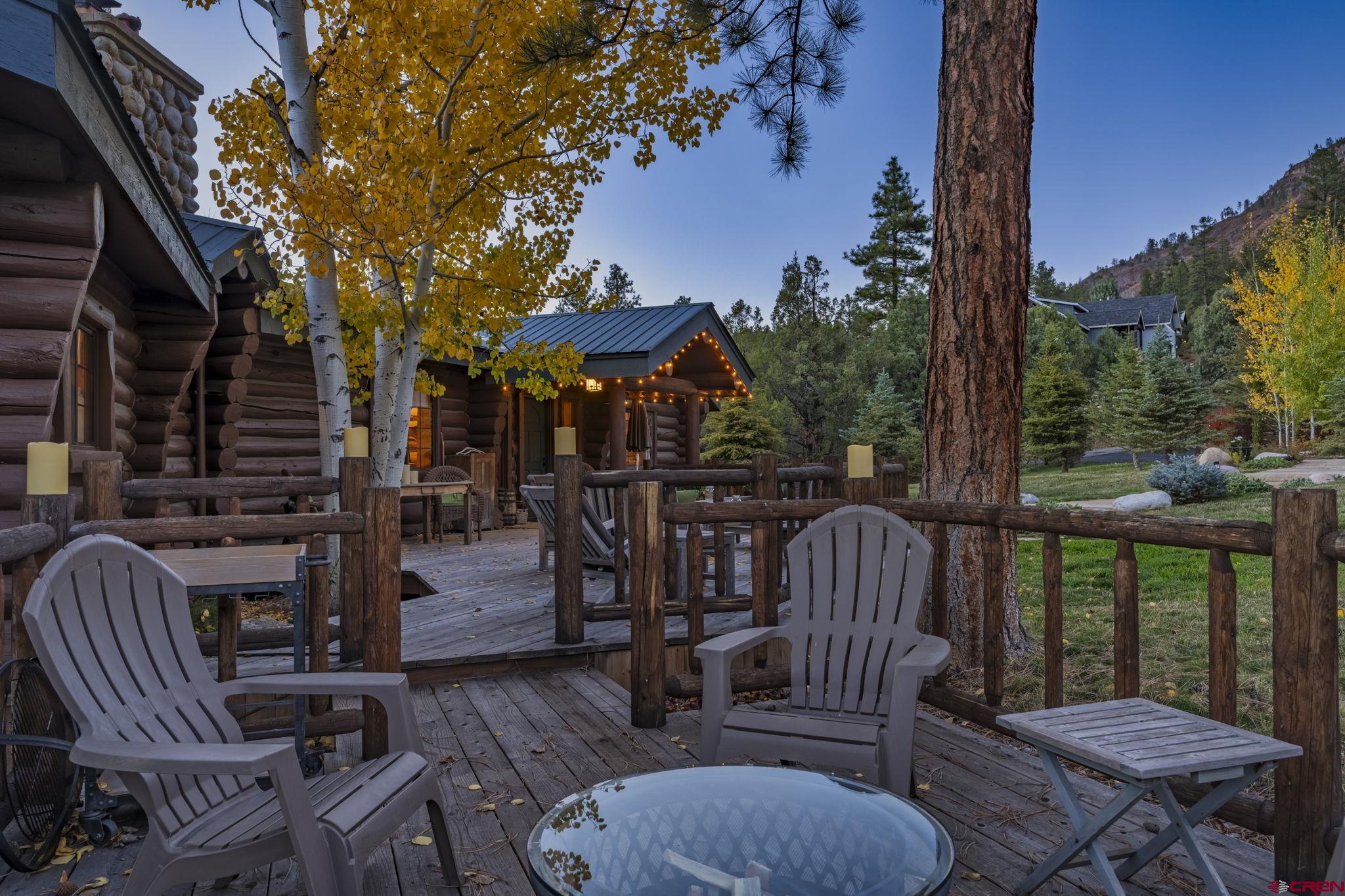 114 Rimrock Drive Durango, CO 81301 - Photo 27 of 42 a view of a patio with couches table and chairs and wooden fence